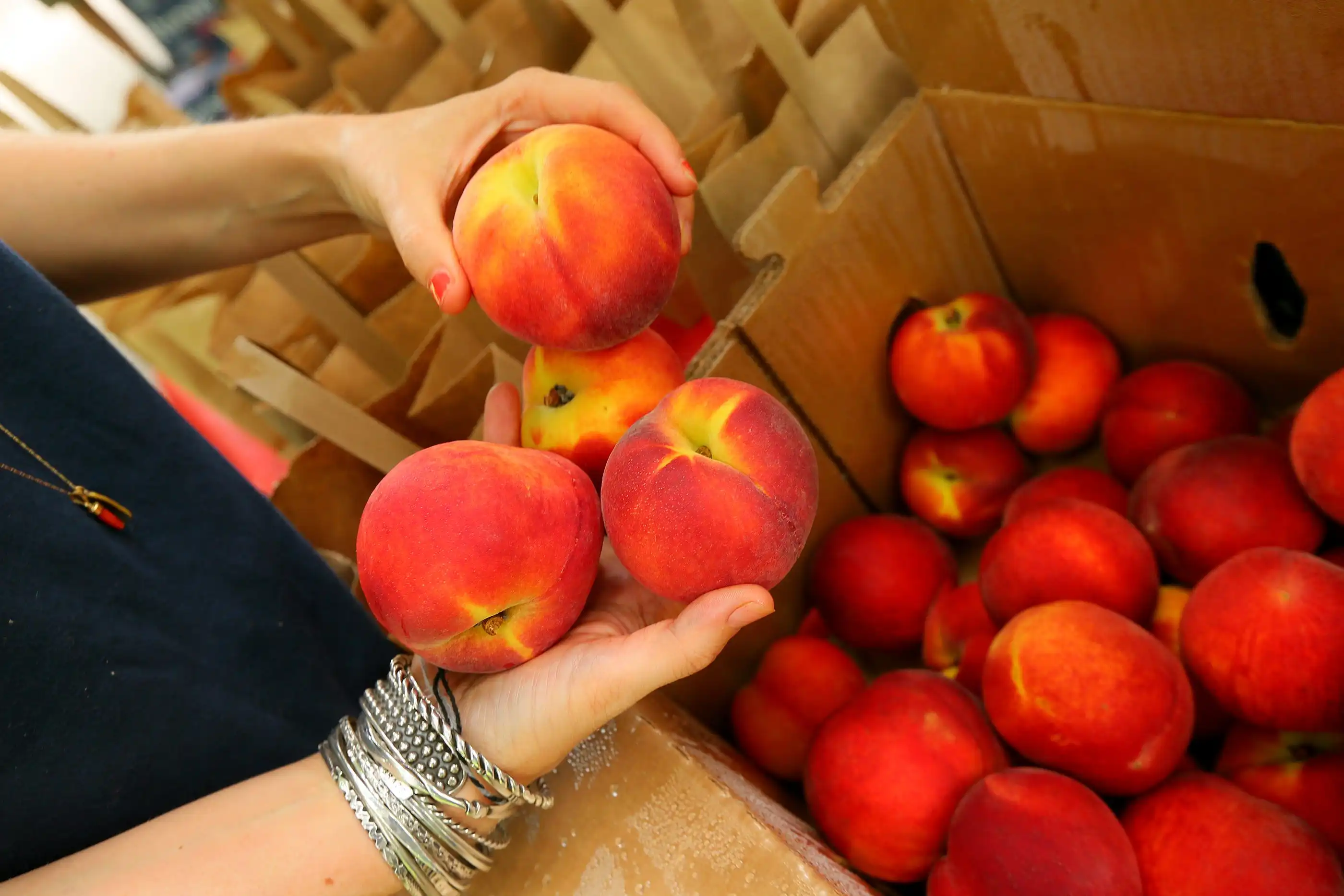 062313 ATLANTA: Ingrid Magnuson grades and bags fresh Georgia grown peaches from the Pearson Farm for customers at the Pearson tent at the Grant Park Farmer's Market on Sunday, June 23, 2013, in Atlanta. CURTIS COMPTON / CCOMPTON@AJC.COM